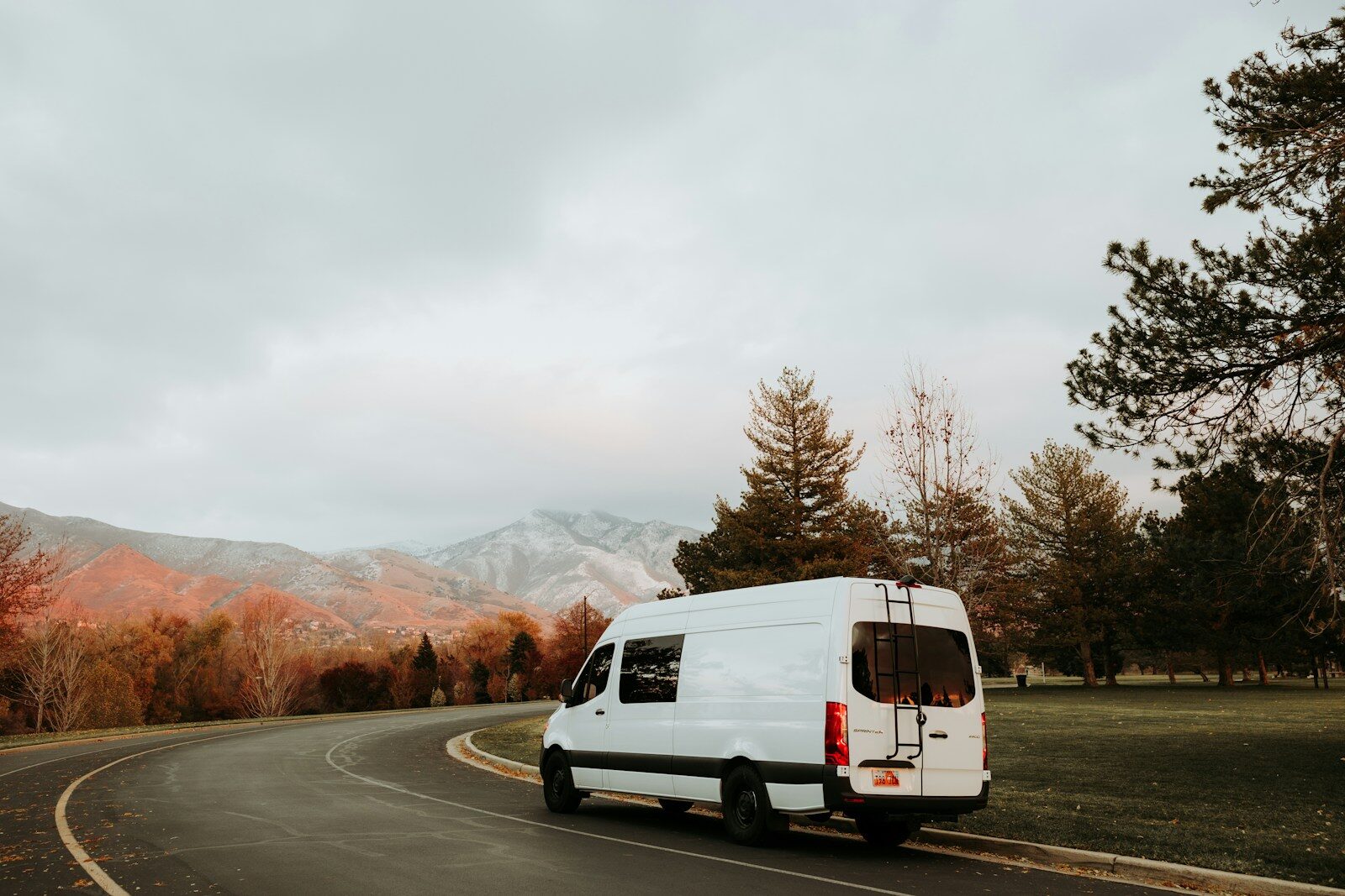 a white van driving down a curvy road